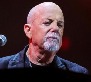 Billy Joel performing live before canceling his tour due to normal pressure hydrocephalus diagnosis.